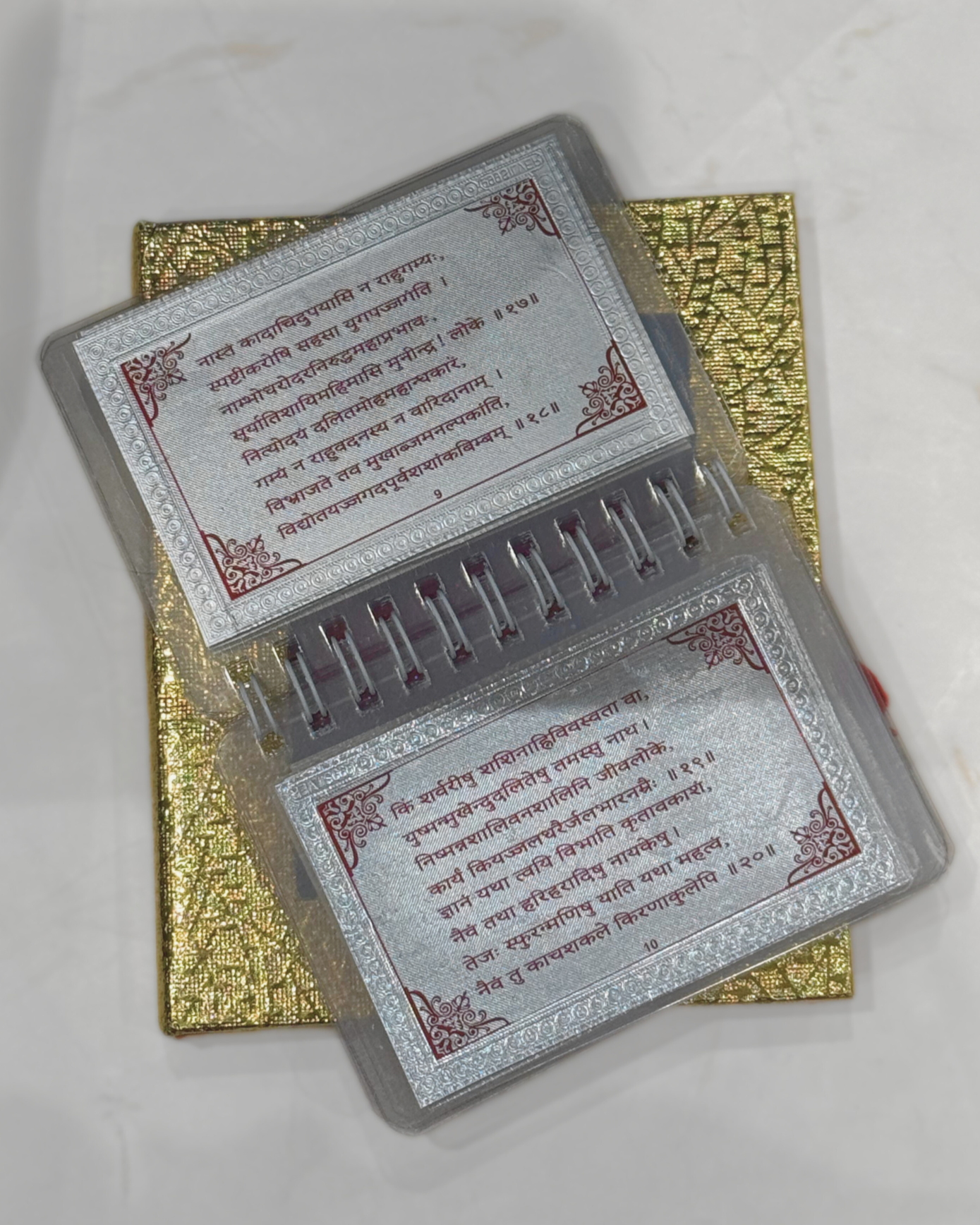 Two metallic prayer book covers with text on a white background