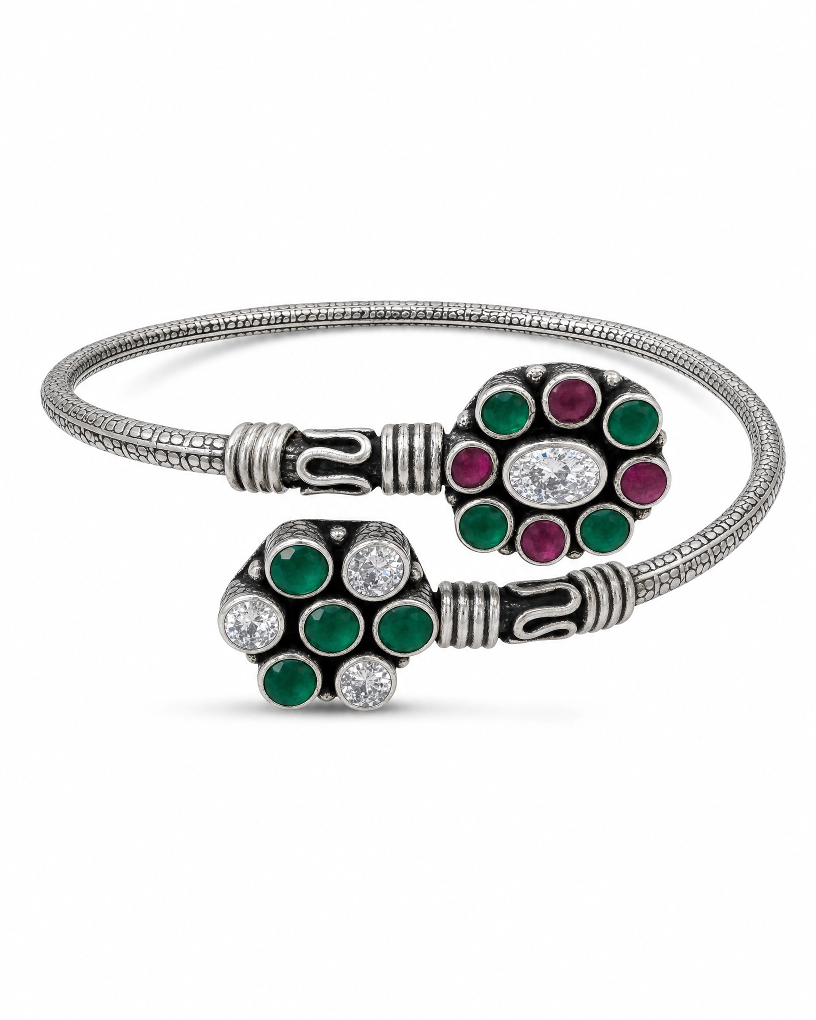 Silver bracelet with green and red gemstone accents on a white background