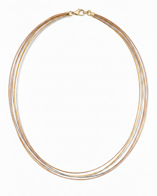 Necklace with multiple gold and silver strands on a white background