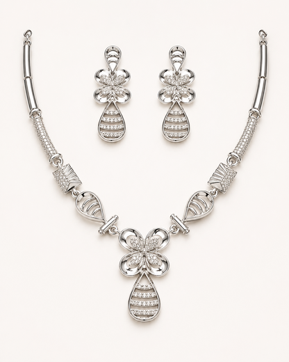Silver necklace and earrings set on a white background
