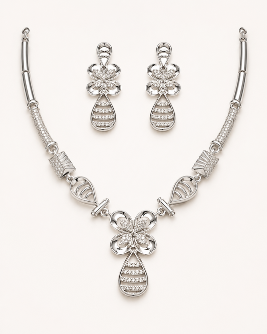 Silver necklace and earrings set on a white background
