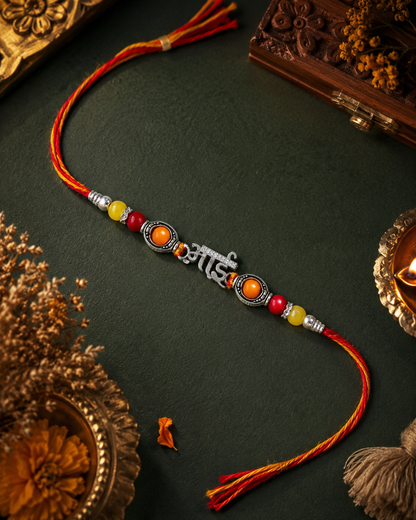 "Bhai" Rakhi with Red, Orange, and Yellow Auspicious Beads