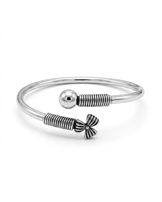 Silver bracelet with a bow-shaped clasp on a white background