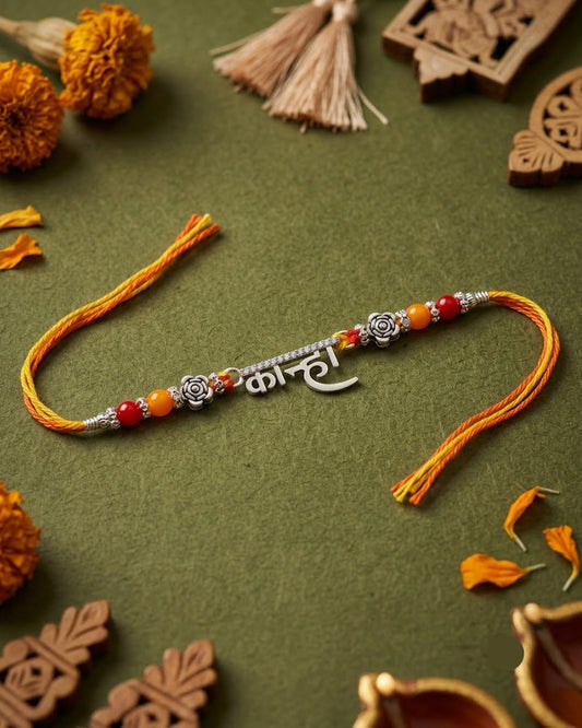 925 sterling silver 'Kanha' script Rakhi with rose motifs and red-yellow festive thread