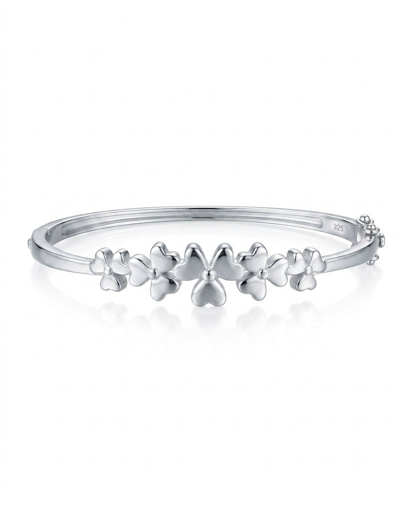 Silver bracelet with floral designs on a white background