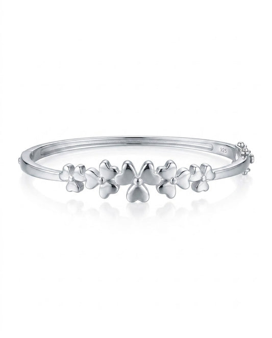 Silver bracelet with floral designs on a white background