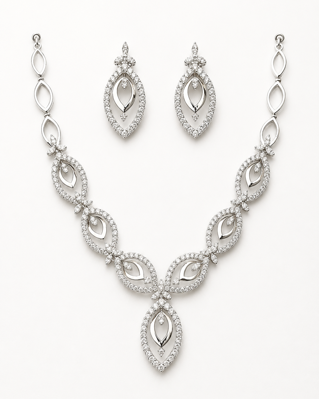 Silver necklace and earrings set on a white background