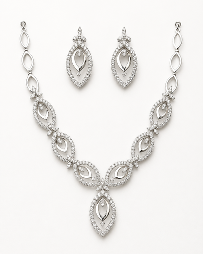 Silver necklace and earrings set on a white background