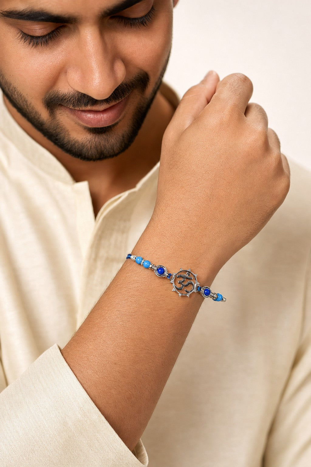 Om Symbol Rakhi Bracelet with Blue Beads - ARU-RAK-0008_model