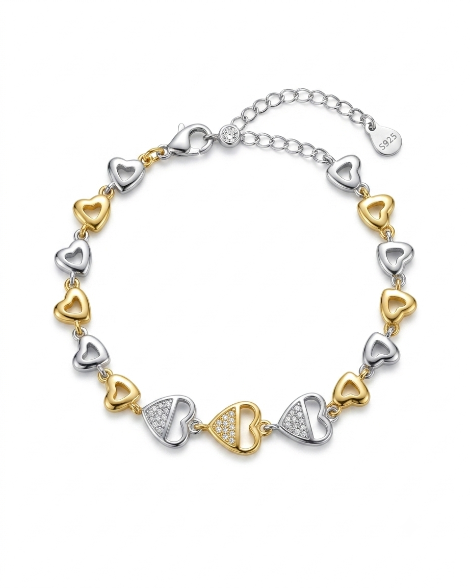 Bracelet with heart-shaped links in gold and silver on a white background