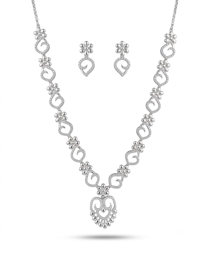 Silver necklace and earrings set on a white background