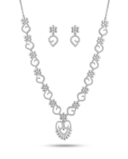 Silver necklace and earrings set on a white background