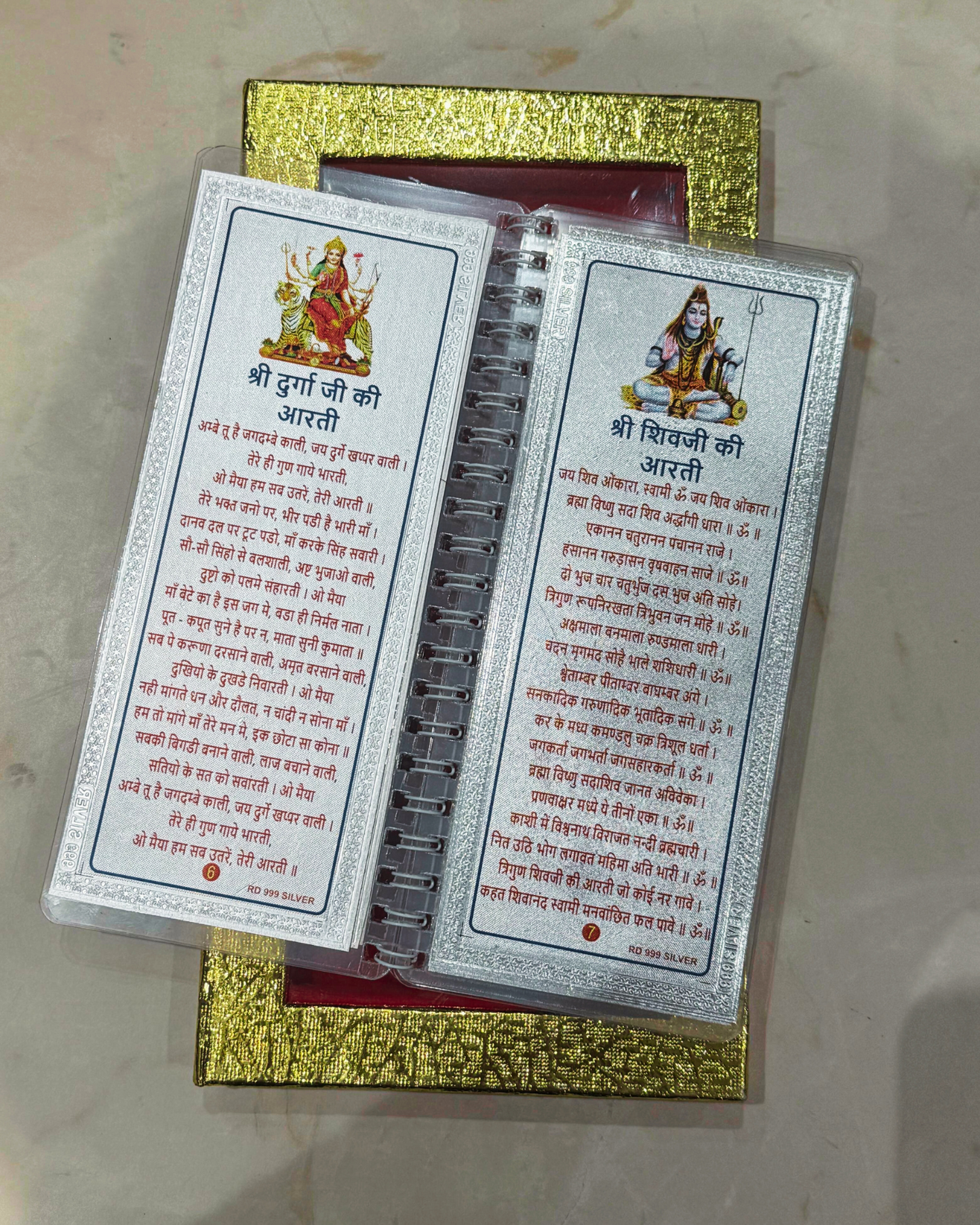 Two prayer cards with text and images on a gold box