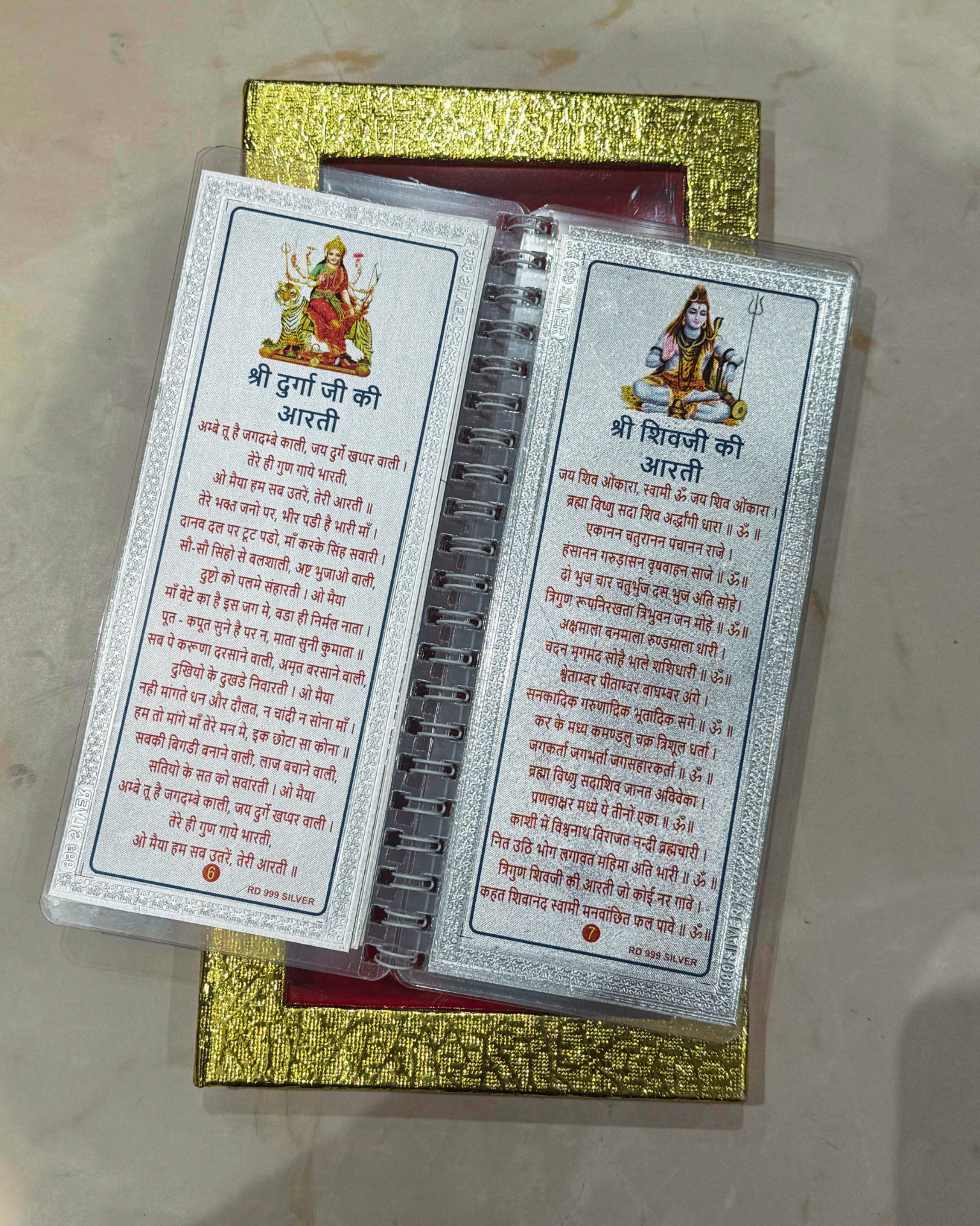 Two prayer cards with text and images on a gold box