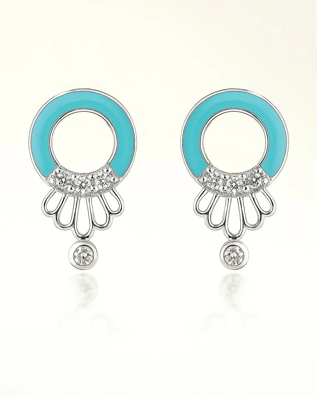 Pair of earrings with turquoise circular tops and silver bases on a white background