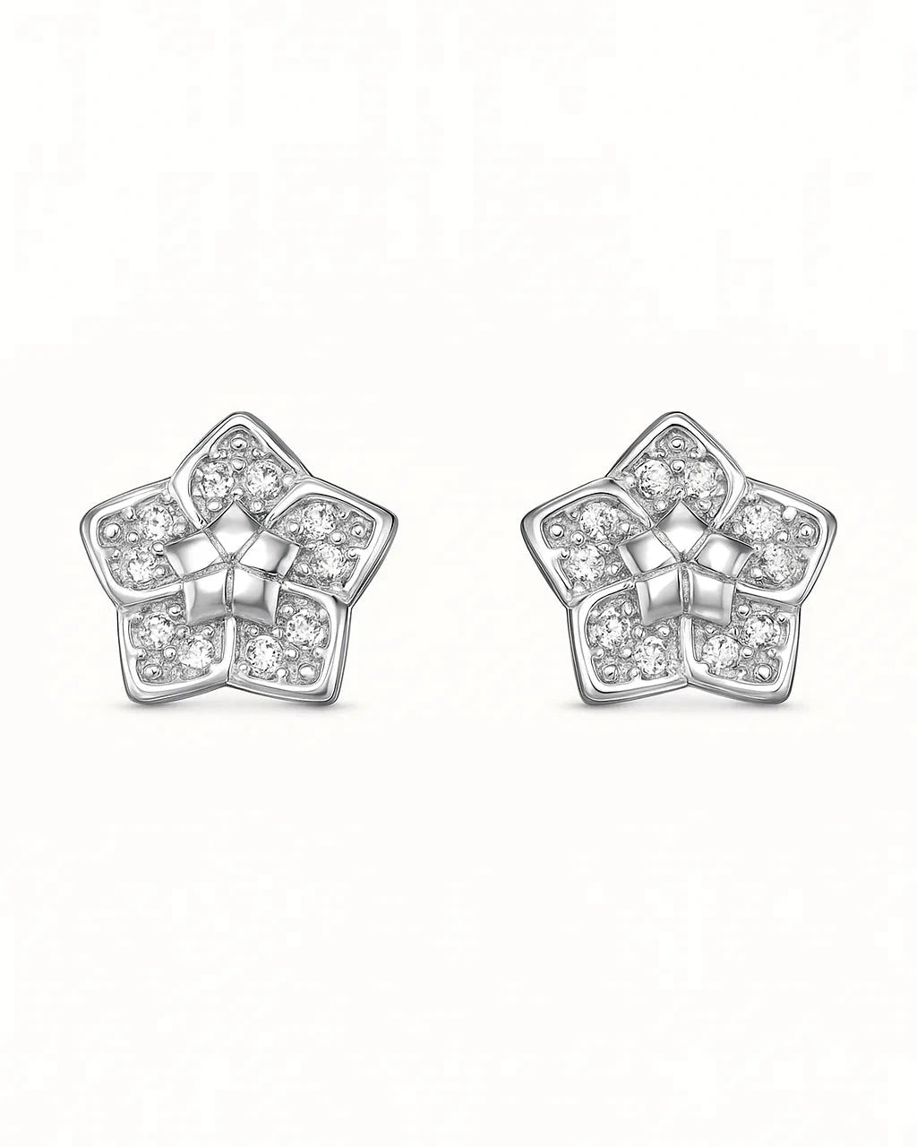 Star-shaped silver earrings with clear gemstones on a white background
