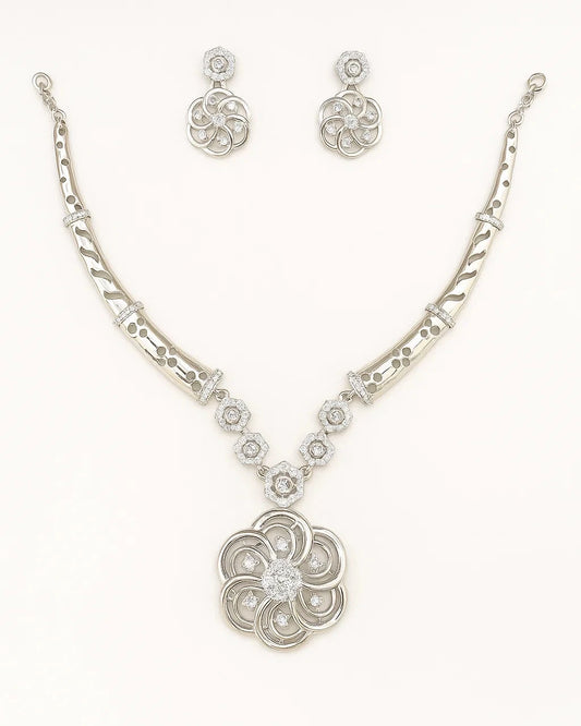 Silver necklace and earrings set on a white background