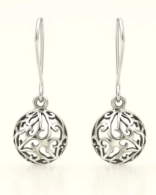 Pair of silver earrings with intricate designs on a white background