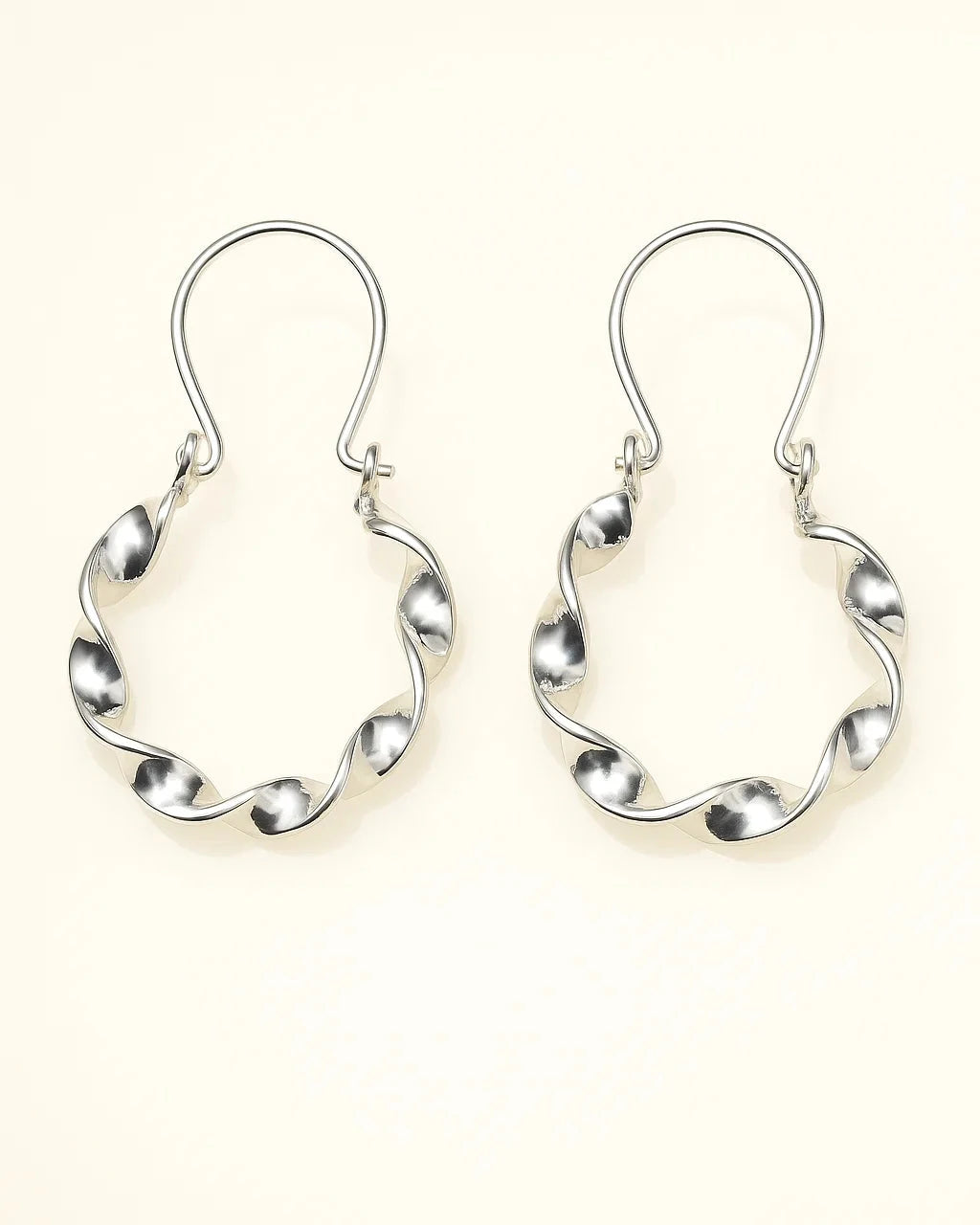 Pair of silver hoop earrings on a white background