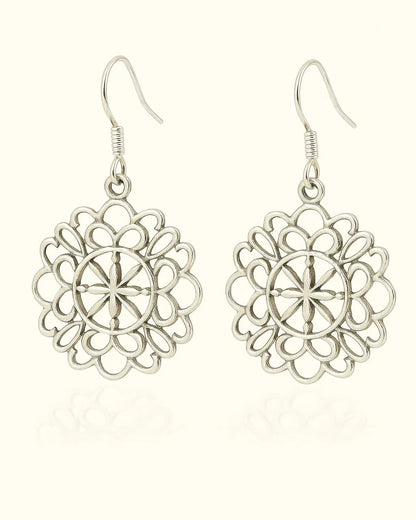 Pair of silver floral earrings on a white background