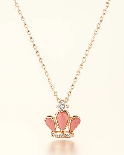 Necklace with a pink crown pendant on a light background