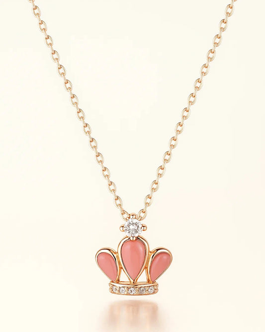 Necklace with a pink crown pendant on a light background