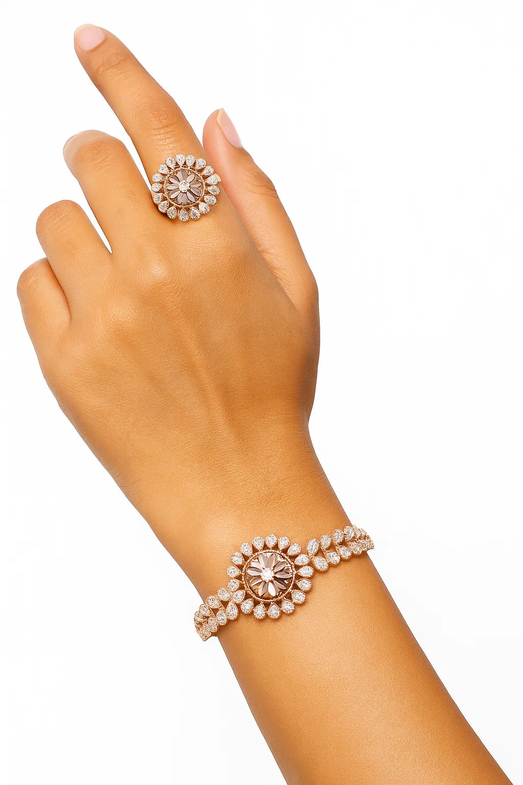 Hand wearing a rose gold ring and bracelet with clear gemstones 
