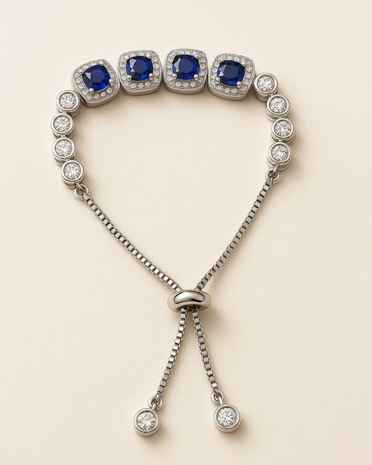 Silver bracelet with blue gemstones on a beige background