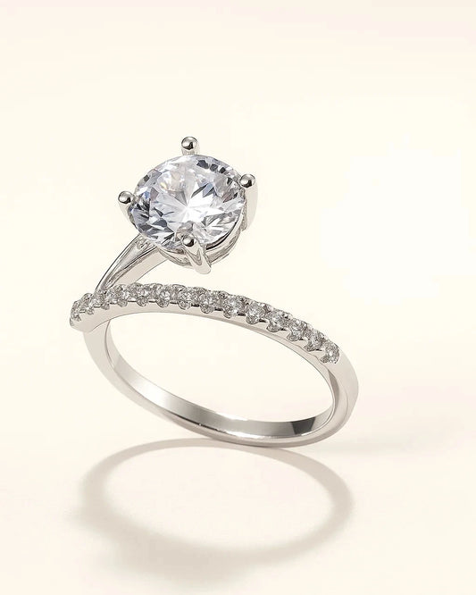 Silver ring with a large central gemstone and smaller stones 