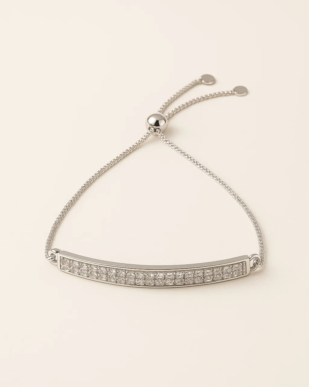 Silver bracelet with clear stones on a beige background