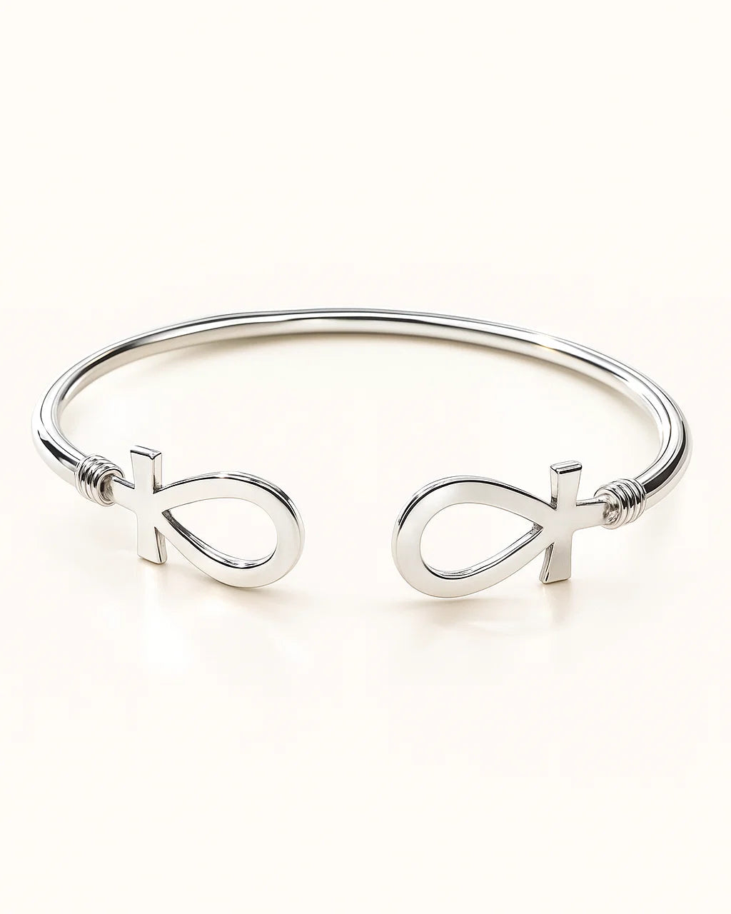 Silver bracelet with fish symbol on a white background