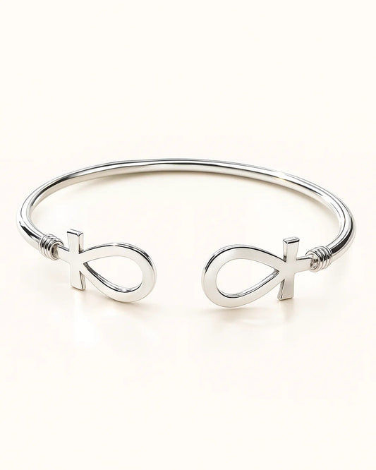 Silver bracelet with fish symbol on a white background