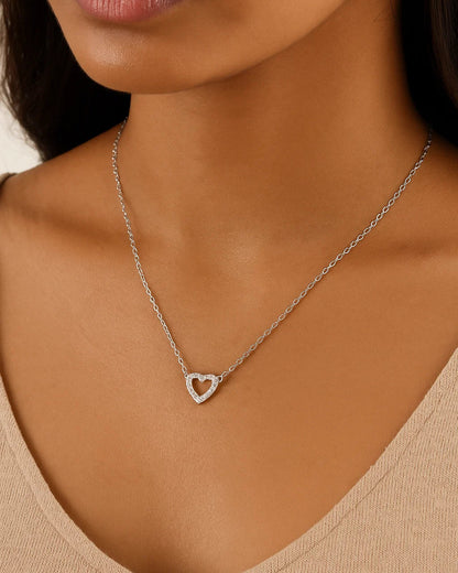 Necklace with a heart pendant worn by a person