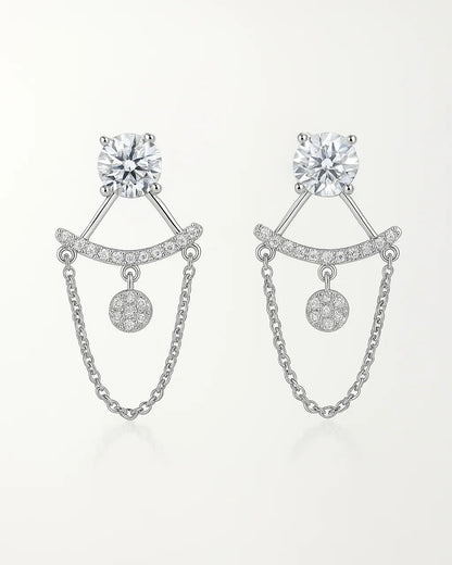 Pair of silver earrings with chain details on a white background