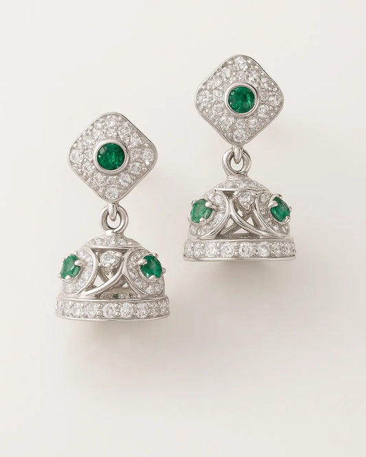 Pair of silver earrings with green gemstones on a white background