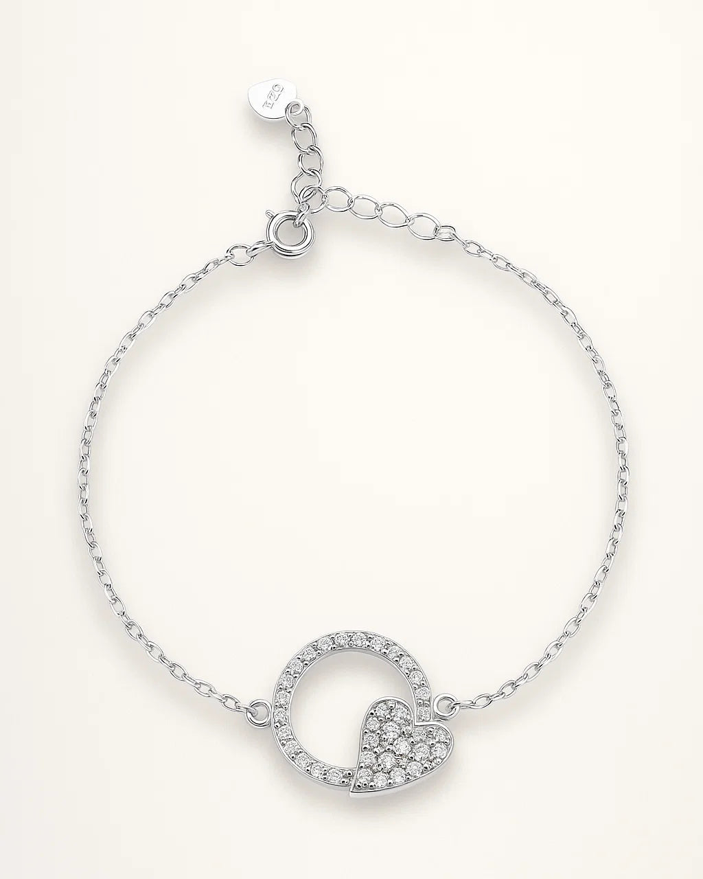 Silver bracelet with heart-shaped charm on a white background