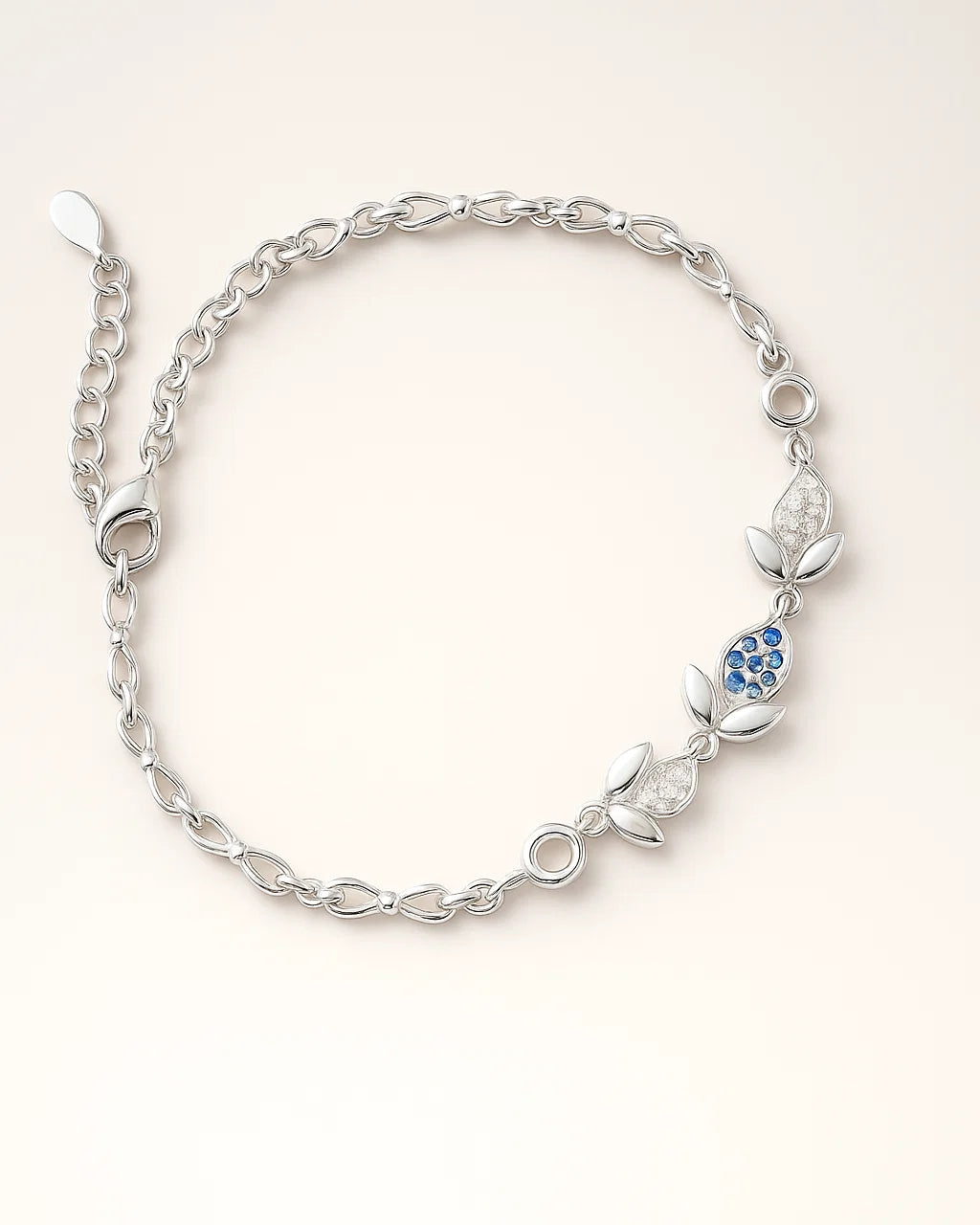 Silver bracelet with blue gemstones on a white background