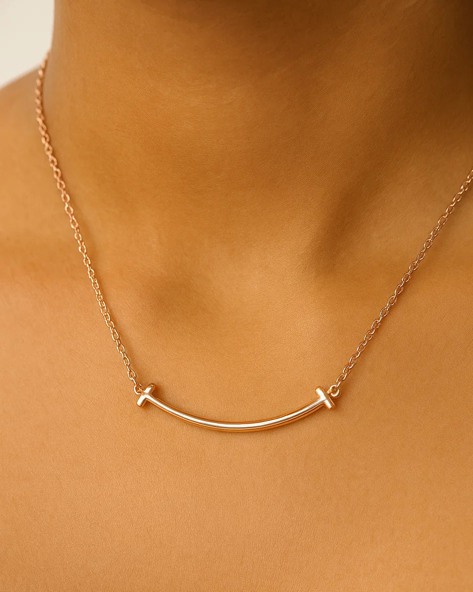 Rose Gold plated necklace on a person's neck against a beige background