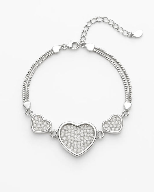 Silver bracelet with heart-shaped charms on a white background