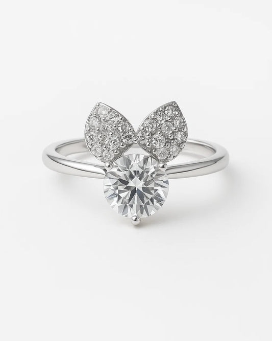 Silver ring with diamond and leaf-like design on a white background