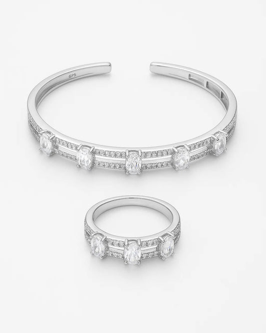 Silver bracelet and ring with diamond accents on a white background