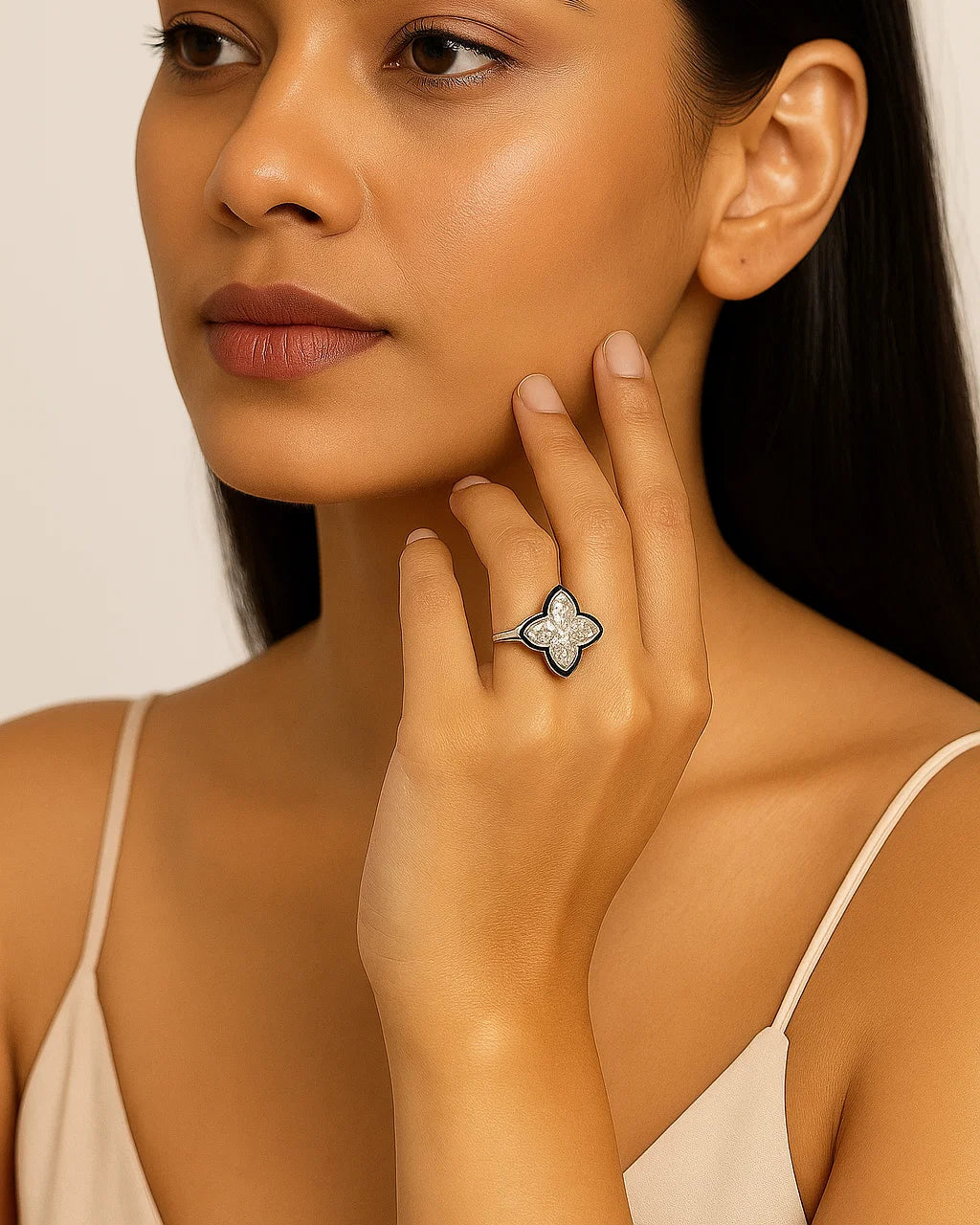 Woman wearing a silver ring with a star design on a beige background