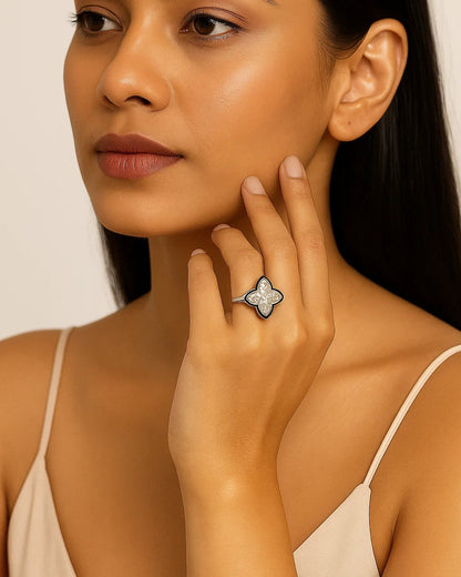 Woman wearing a silver ring with a star design on a beige background