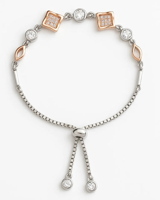 Silver bracelet with rose gold accents and clear gemstones on a white background