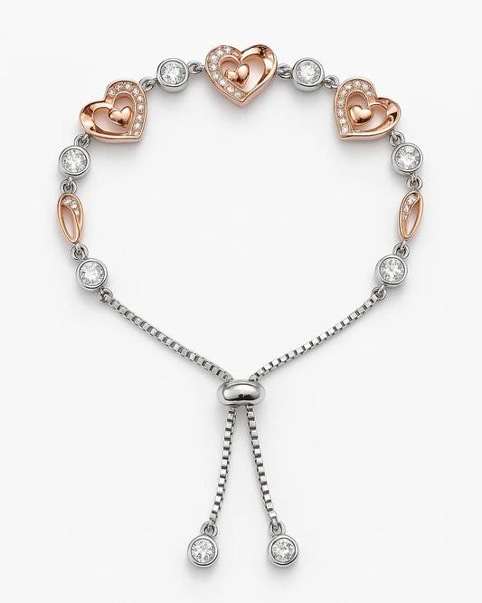 Bracelet with heart-shaped charms and clear stones on a white background