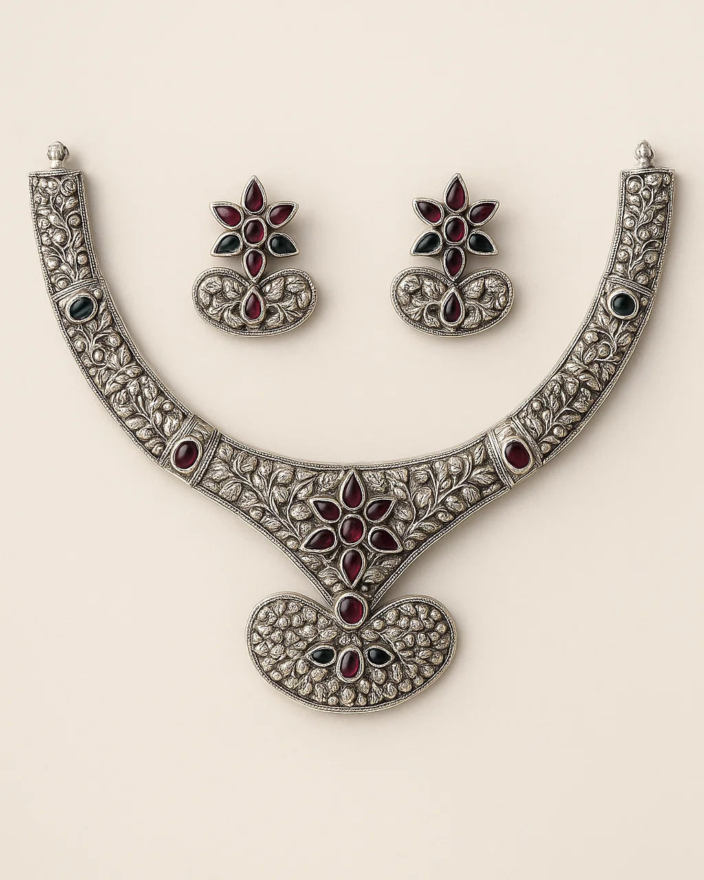Ornate necklace and earrings set on a beige background