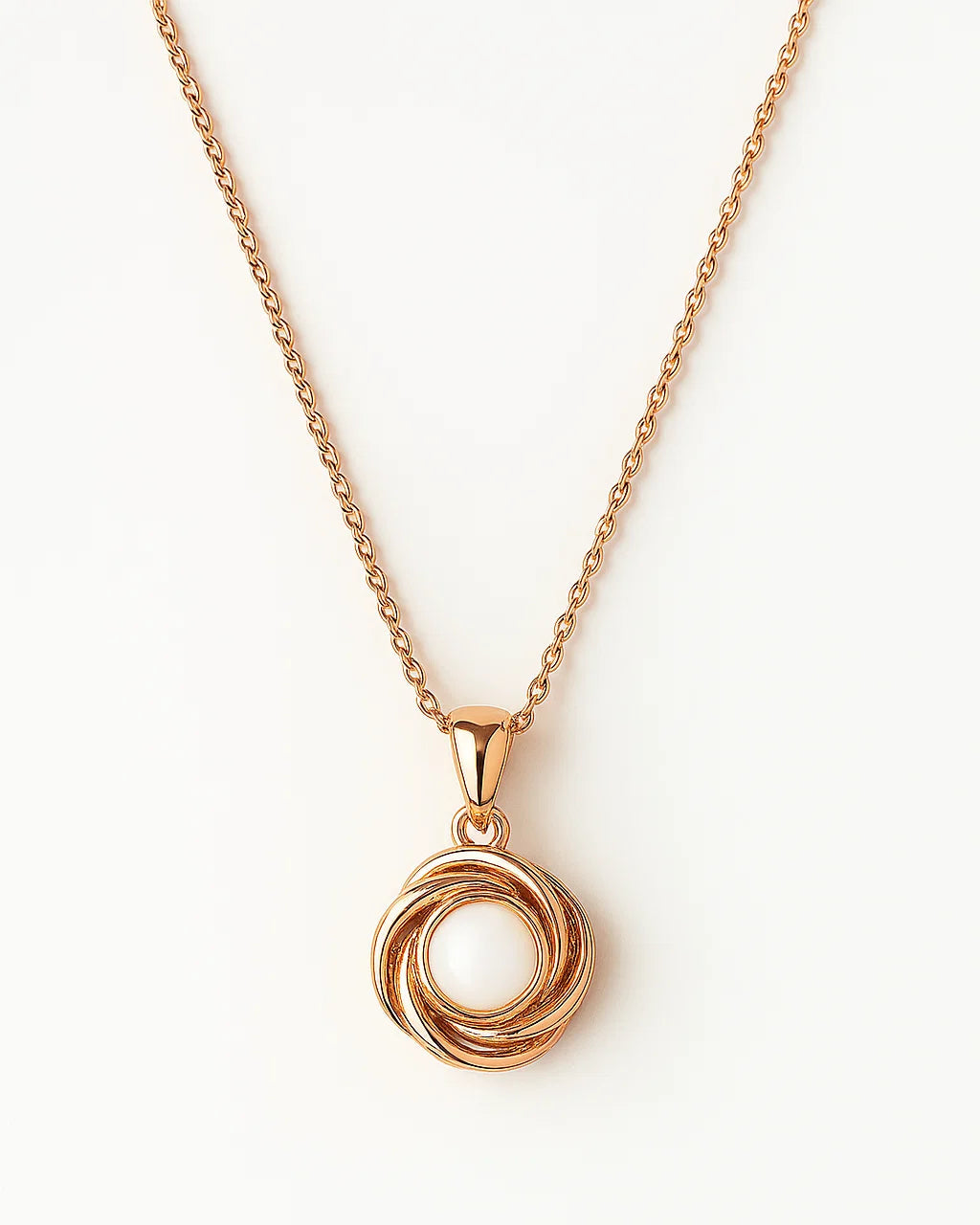 Rose gold necklace with a circular pendant on a white background