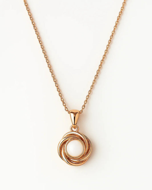 Rose gold necklace with a circular pendant on a white background