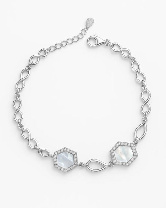Silver bracelet with hexagonal gemstones on a white background