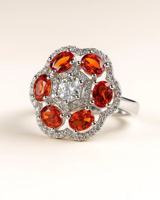 Ring with orange gemstones and a central diamond on a beige background